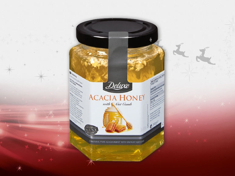 Miele di acacia con un vero favo di miele